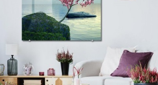 Obraz na szkle do salonu - Różowe kwitnące drzewo nad oceanem