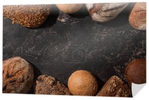 widok z góry świeżego pieczonego chleba i bułek na kamiennej czarnej powierzchni