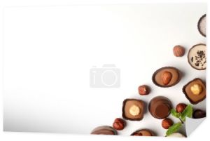 Płaska kompozycja świecka z czekoladowymi cukierkami na białym tle