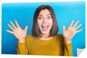 Photo of excited cheerful woman wear shirt smiling open mouth rising arms palms isolated blue color background