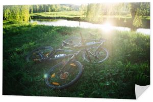 Mountain bikes on the river bank on a summer evening