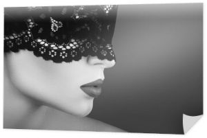 Young beautiful woman wearing black lace blindfold