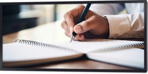 Focused Writer Jots Down Important Notes in an Open Notebook With a Pen