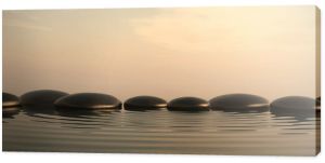 Kamienie Zen w wodzie o wschodzie słońca