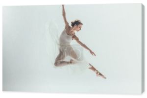 Piękna tancerka w białej sukni skoki w studio, na białym tle