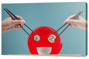 Mężczyzna i kobieta jedzący sushi razem przy użyciu pałeczek, kuchnia azjatycka koncepcja