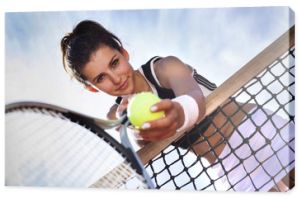 Piękna młoda dziewczyna spoczywa na siatce do tenisa