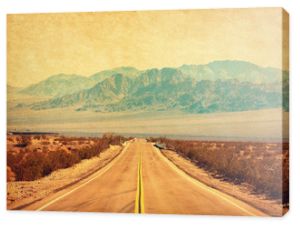 Route 66 crossing the Mojave Desert, California, United States.  Photo in retro style. Added paper texture. Toned image