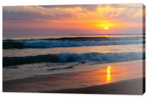 Amazing sunset sea scenery with waves and sandy beach